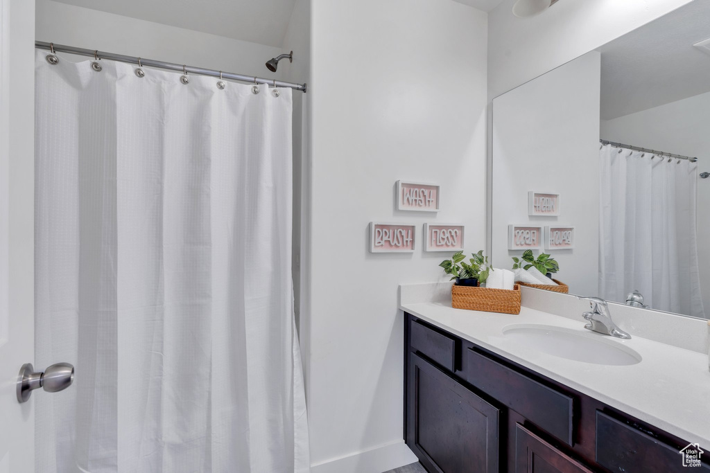 Bathroom with vanity and curtained shower