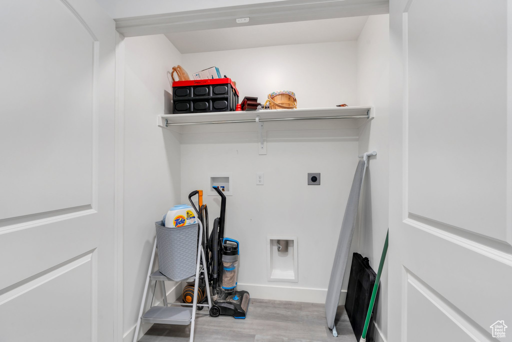 Washroom featuring washer hookup, wood finished floors, and hookup for an electric dryer
