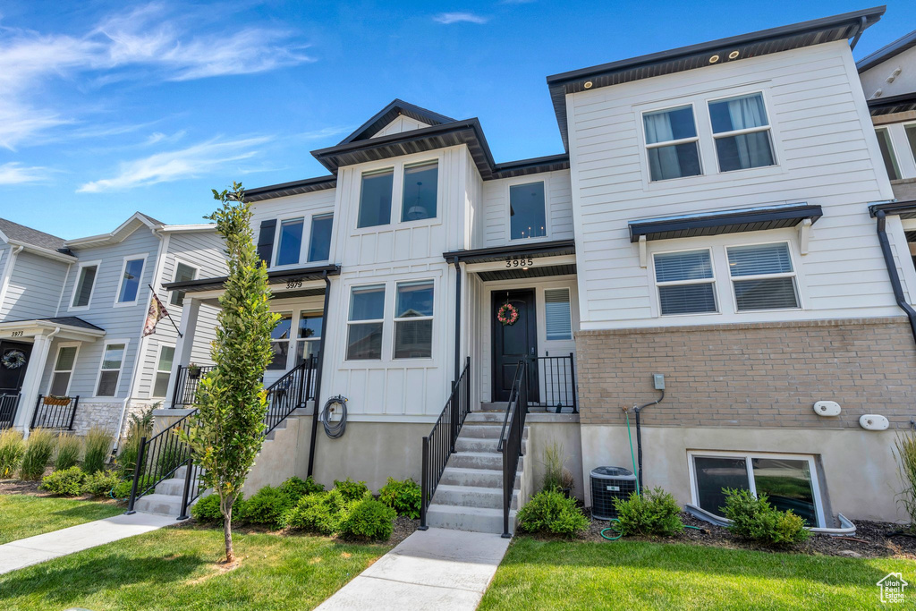 Townhome / multi-family property featuring brick siding
