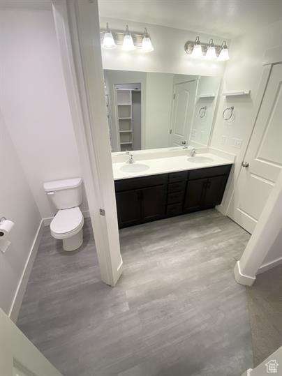 Bathroom featuring wood finished floors and double vanity