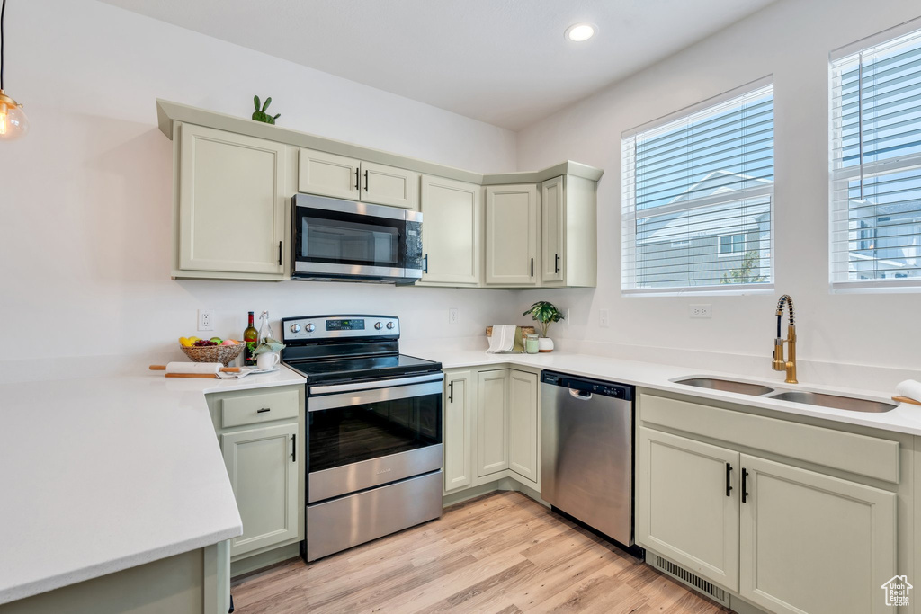 Kitchen featuring appliances with stainless steel finishes, plenty of natural light, light countertops, and recessed lighting