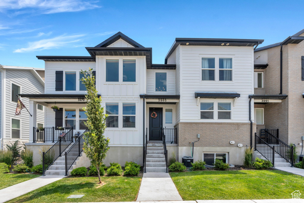 Multi unit property with a front lawn and board and batten siding