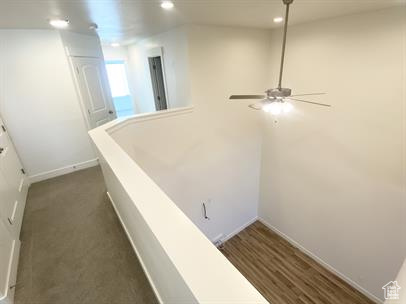 Corridor with baseboards and recessed lighting