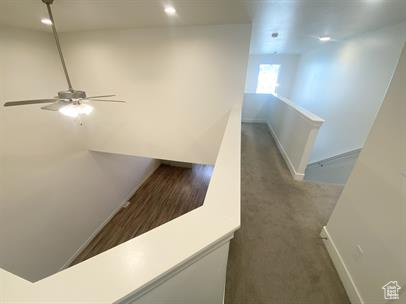 Staircase featuring recessed lighting and ceiling fan
