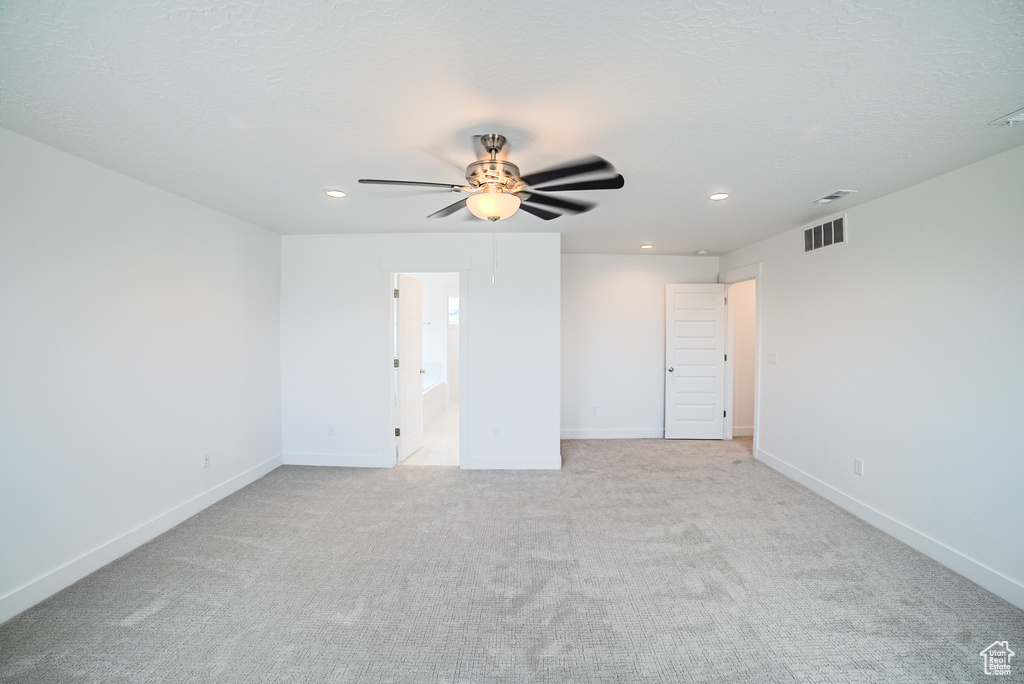 Unfurnished room featuring ceiling fan, recessed lighting, and light carpet