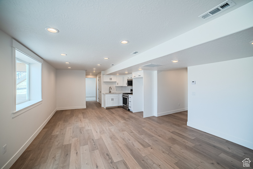 Unfurnished living room featuring recessed lighting and light wood finished floors