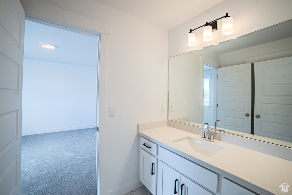 Bathroom featuring vanity and baseboards