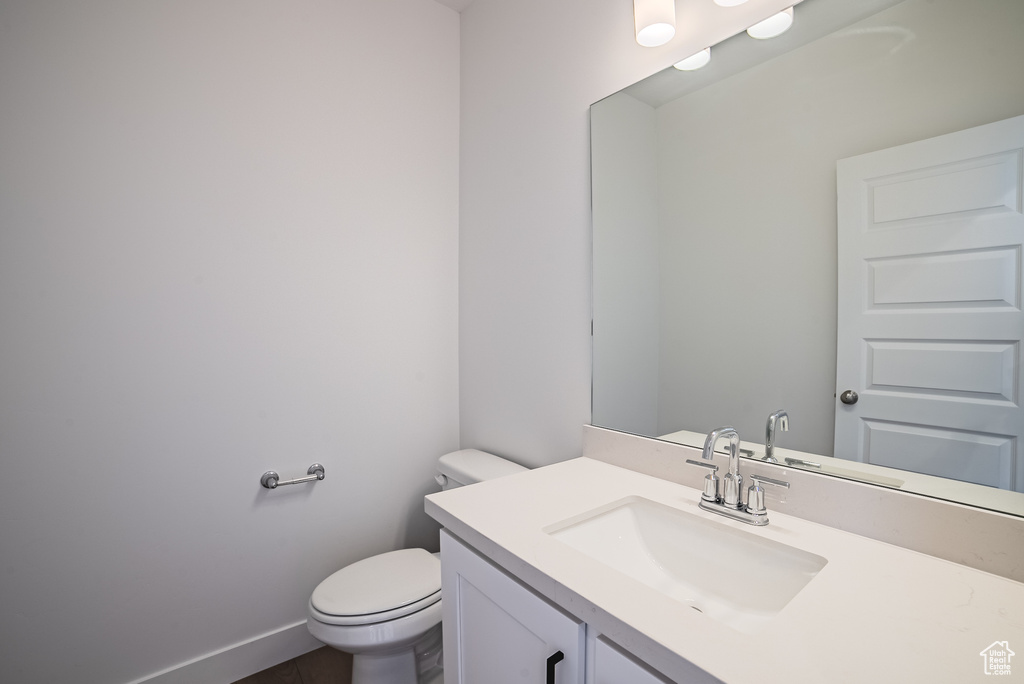 Half bath featuring toilet and vanity