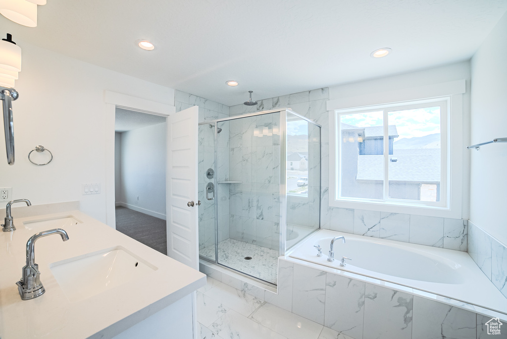 Bathroom featuring a marble finish shower, marble finish floors, a garden tub, double vanity, and recessed lighting