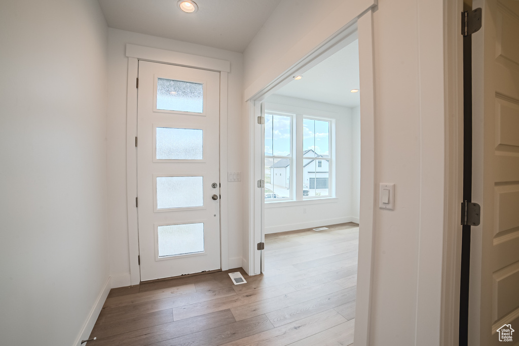 Foyer featuring wood-type flooring and recessed lighting