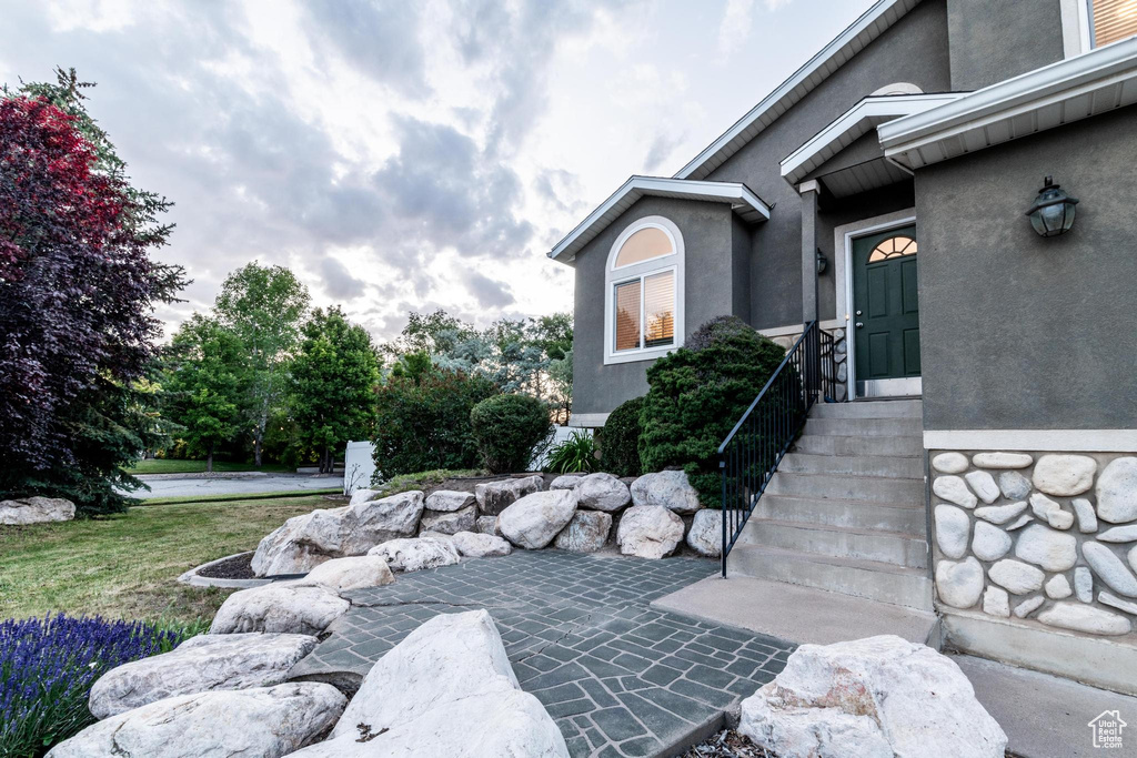 View of exterior entry featuring stucco siding