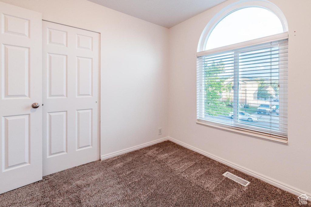 Unfurnished bedroom with carpet floors and baseboards