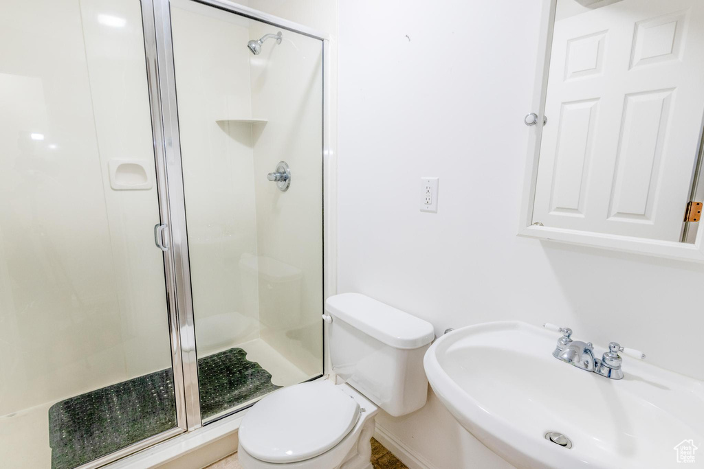 Full bath featuring a sink and a stall shower