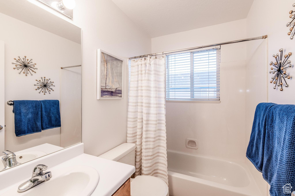 Full bath featuring shower / tub combo and vanity