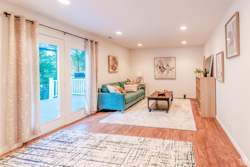 Living area featuring light wood-style flooring and recessed lighting