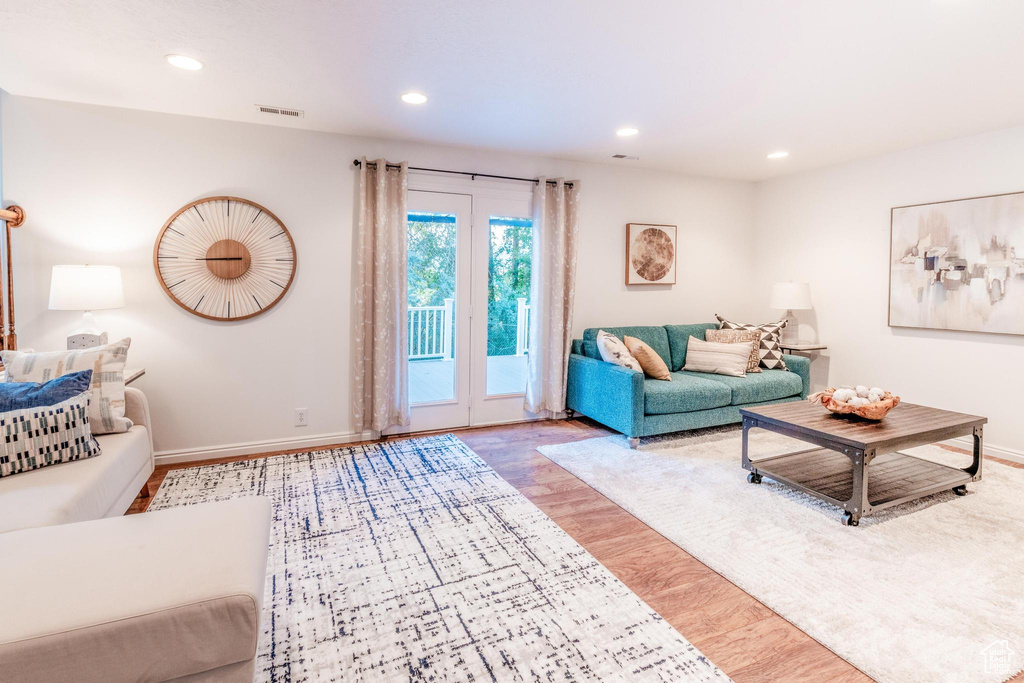 Living room with recessed lighting and wood finished floors