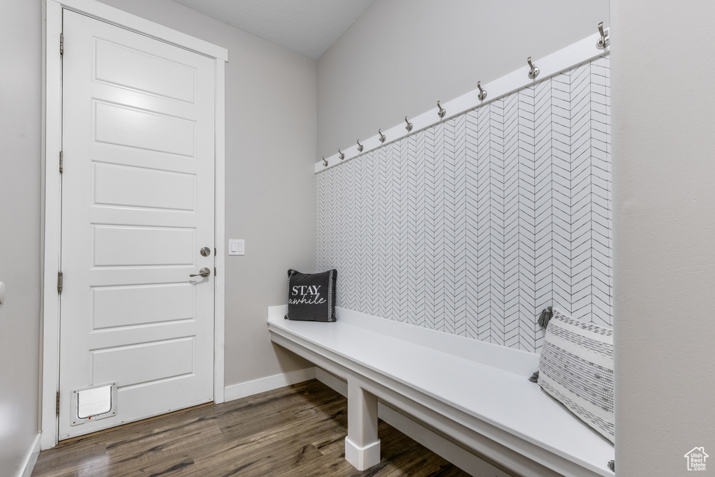 Mudroom featuring dark wood-style floors and baseboards