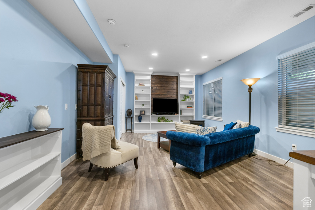 Living area featuring wood finished floors and recessed lighting