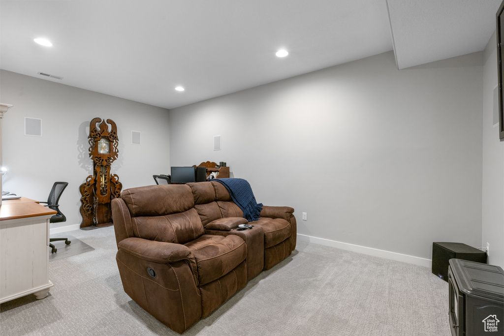 Home office with light carpet and recessed lighting