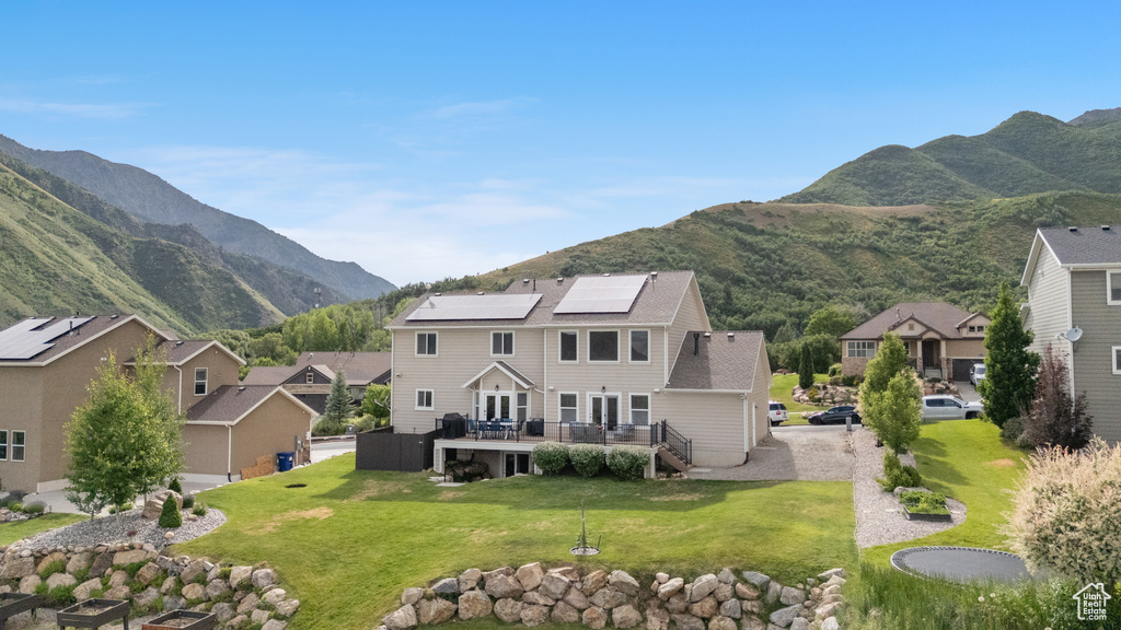 View of mountain backdrop featuring nearby suburban area