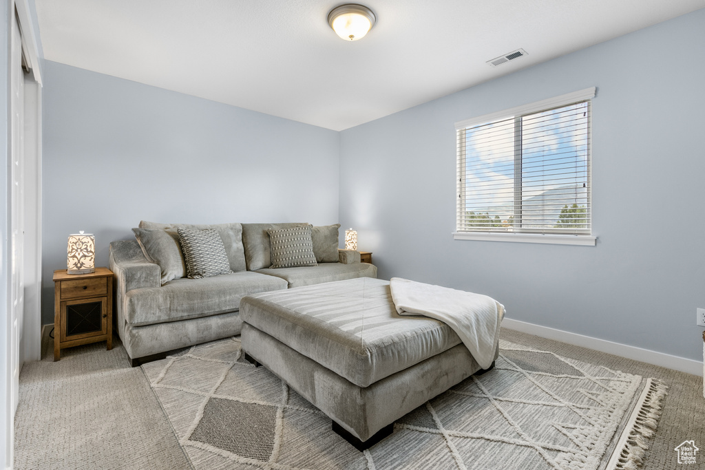 Living room featuring carpet and baseboards
