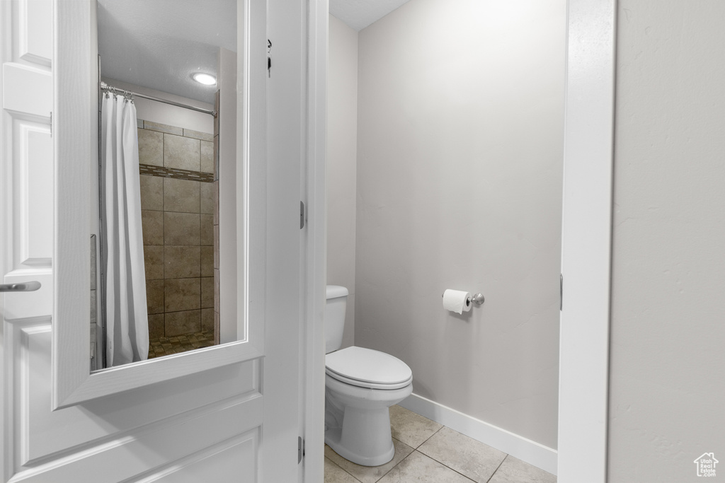 Full bathroom featuring tile patterned floors and tiled shower