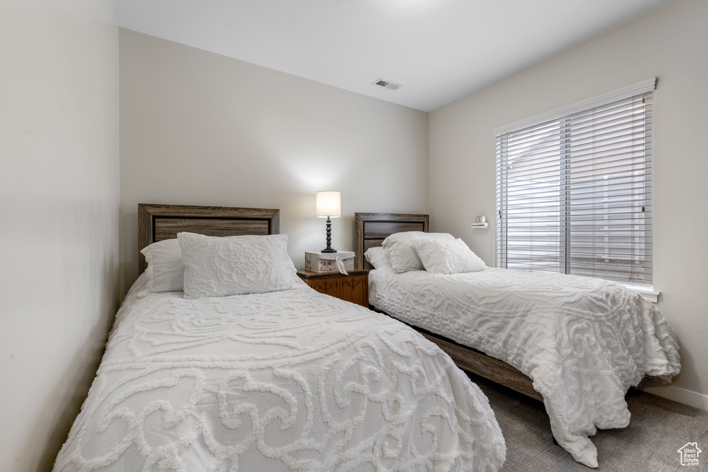 Bedroom featuring baseboards and carpet flooring