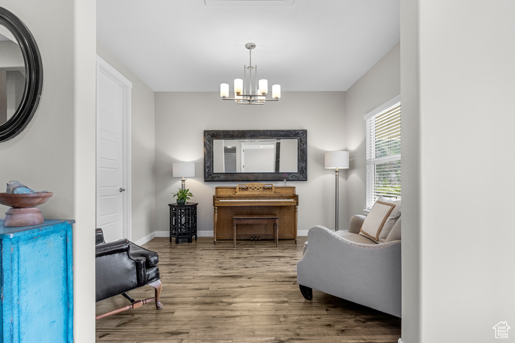 Sitting room featuring wood finished floors and a chandelier