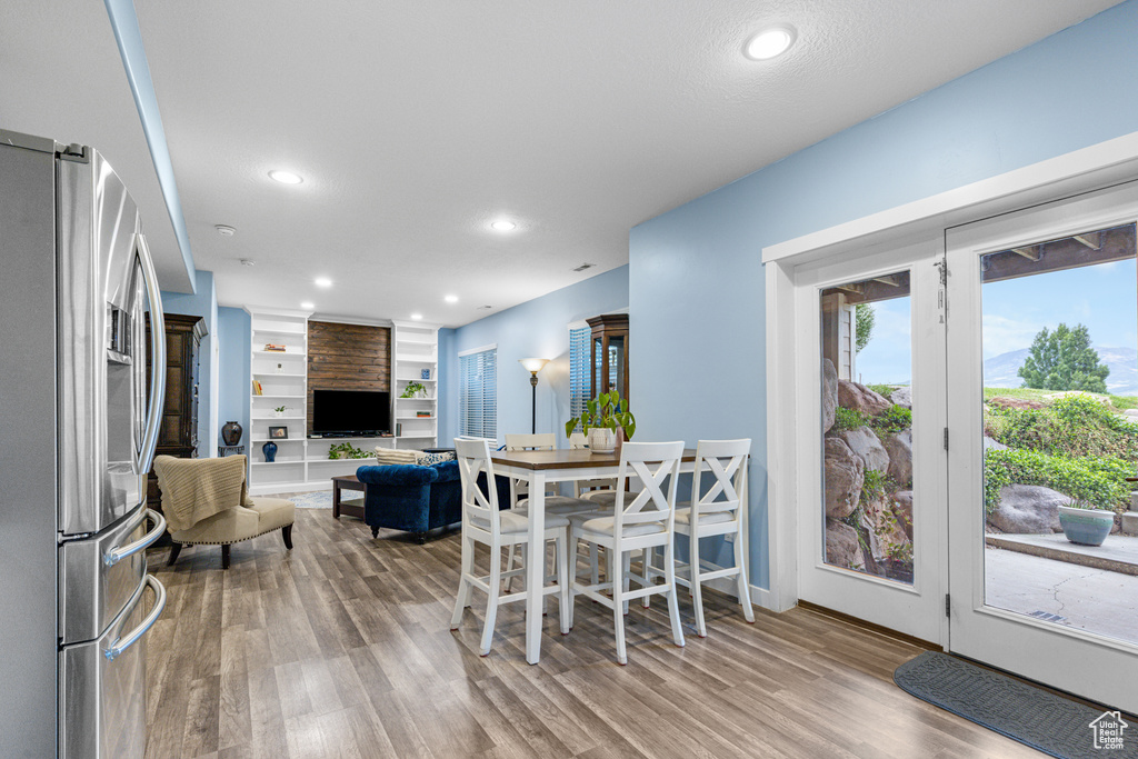 Dining space featuring wood finished floors and recessed lighting