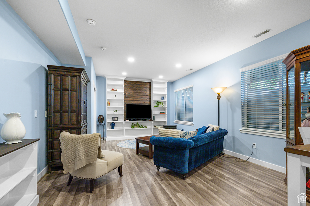 Living room featuring wood finished floors and recessed lighting