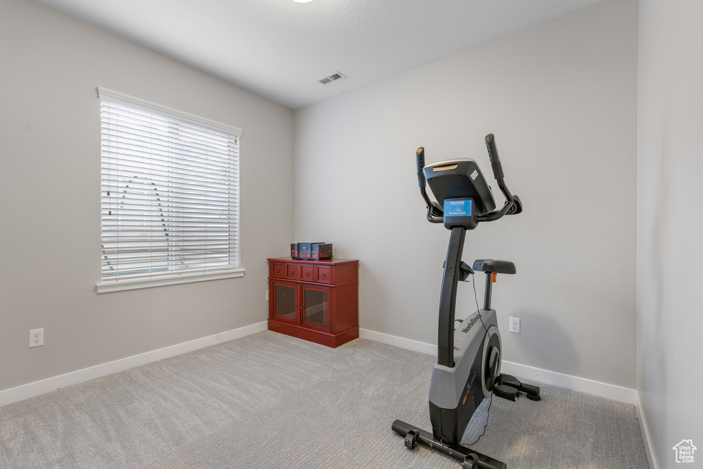 Workout area featuring carpet and baseboards