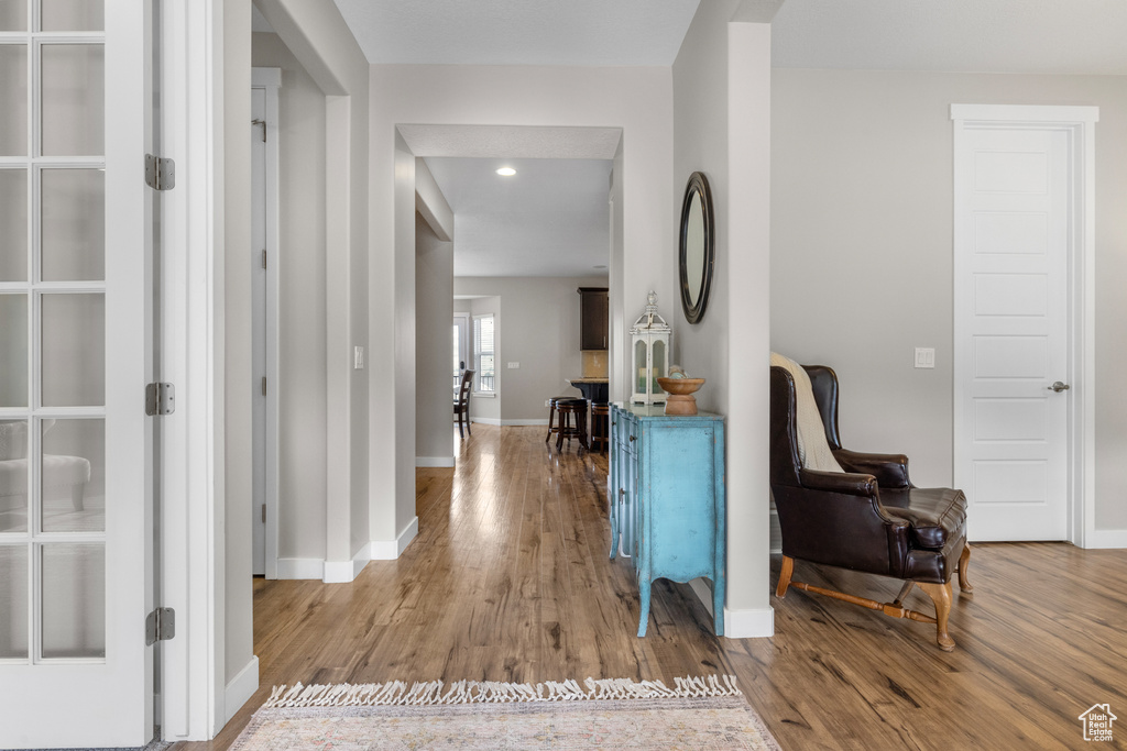 Entryway with wood finished floors and recessed lighting