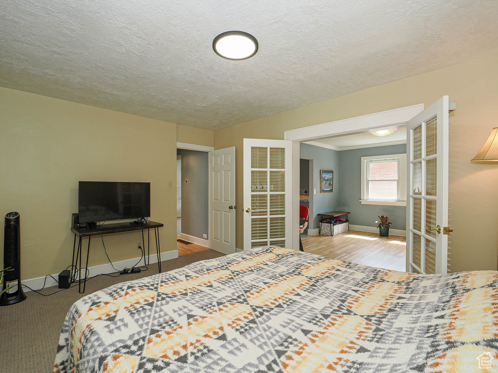 Bedroom with a textured ceiling and french doors
