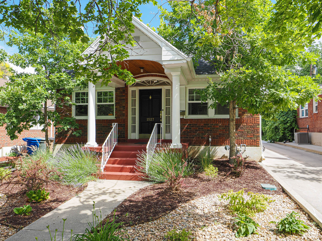 Bungalow-style house with brick siding