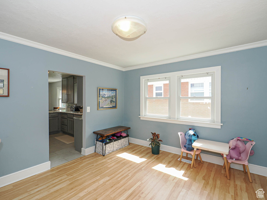 Unfurnished room with ornamental molding and light wood finished floors