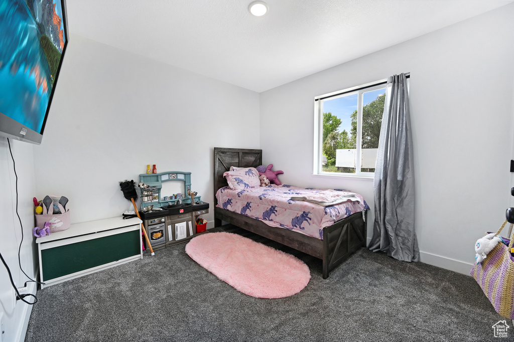 Carpeted bedroom featuring baseboards
