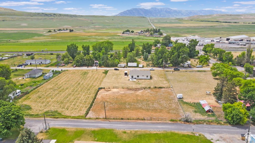 Overview of rural landscape featuring abundant farmland and a mountainous background