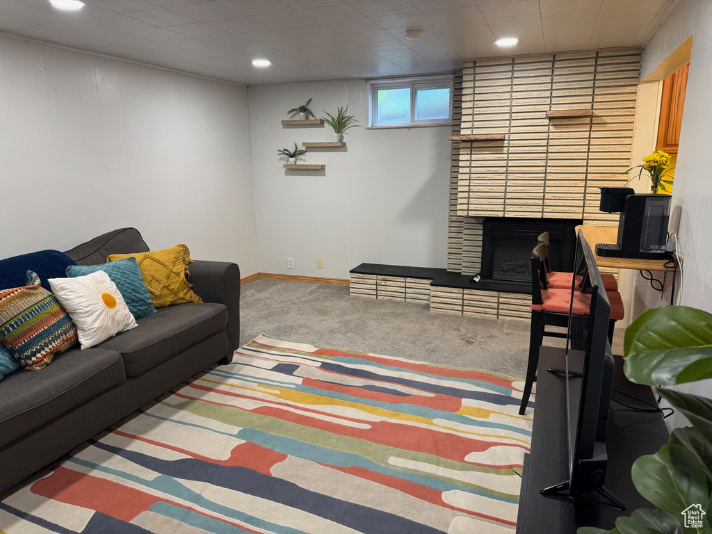 Living area with carpet, a fireplace, and recessed lighting