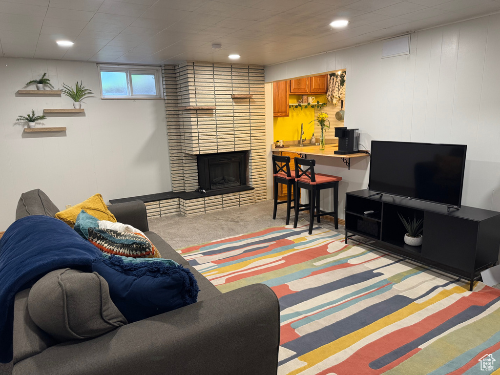 Living area featuring recessed lighting, carpet flooring, and a fireplace