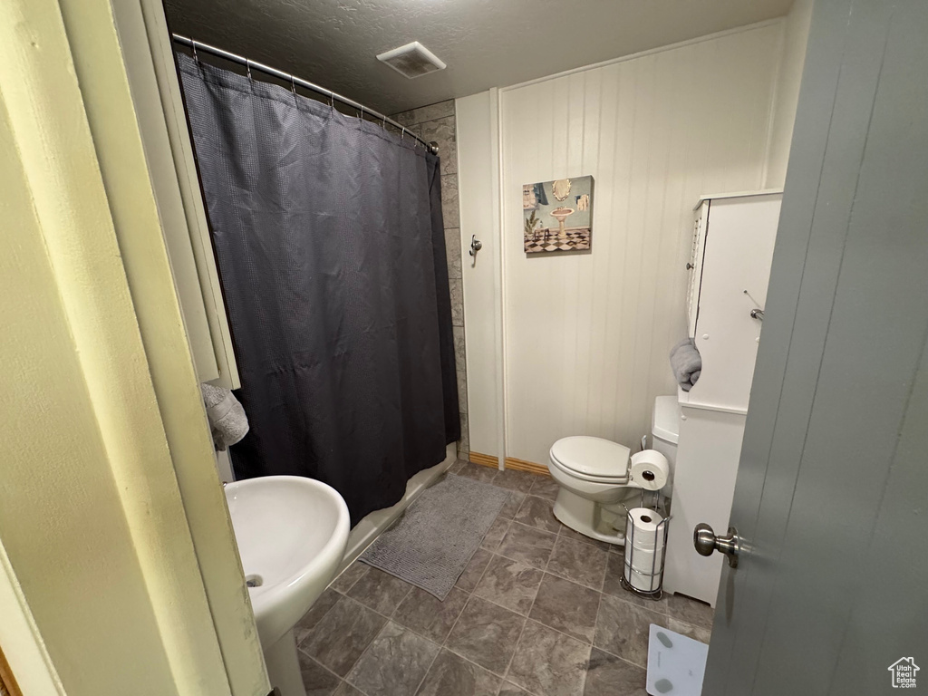 Bathroom featuring a shower with curtain
