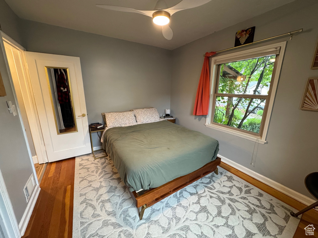 Bedroom with wood finished floors and a ceiling fan