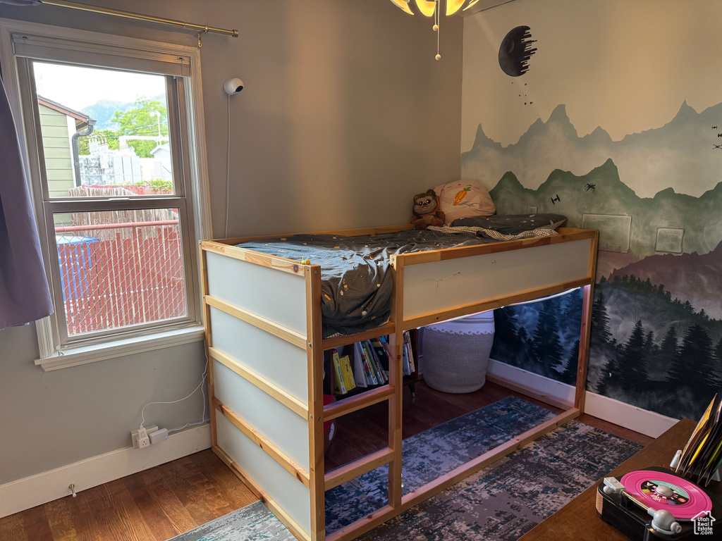 Bedroom featuring wood finished floors and baseboards