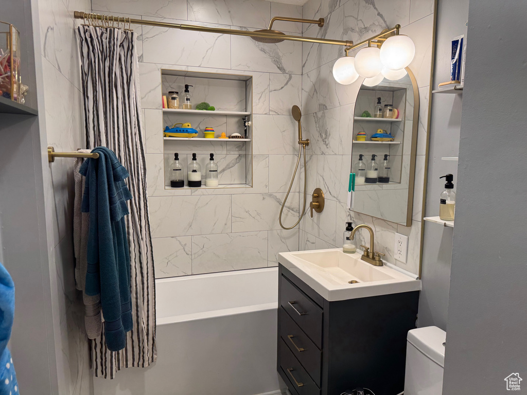 Bathroom featuring shower / tub combo with curtain and vanity