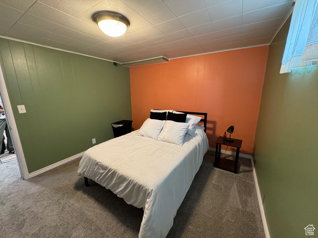 Carpeted bedroom featuring baseboards