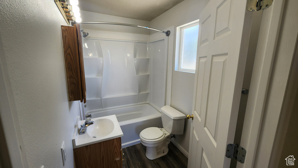 Full bathroom featuring vanity, wood finished floors, and bathing tub / shower combination