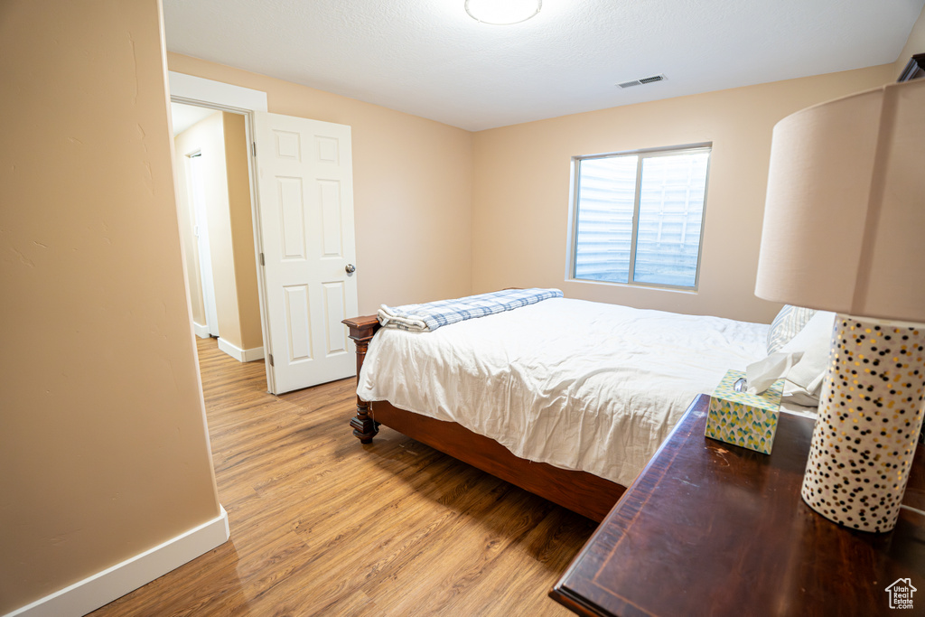 Bedroom with baseboards and light wood finished floors