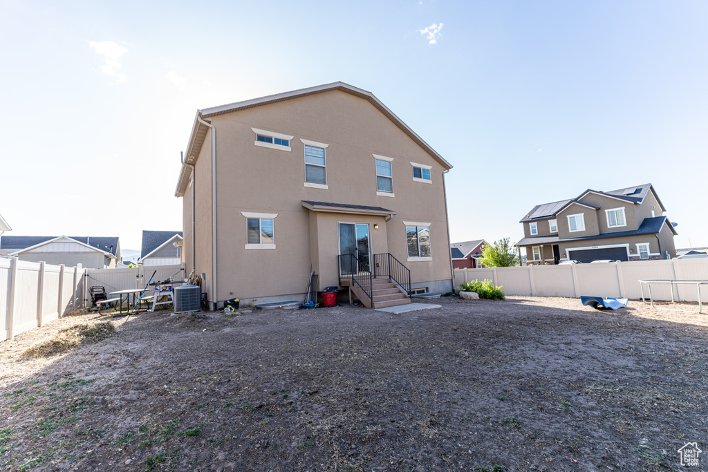 Back of house featuring a fenced backyard and stucco siding