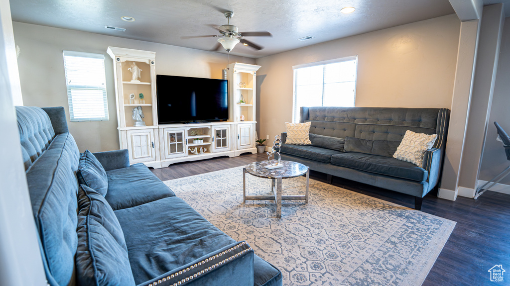 Living area featuring plenty of natural light, ceiling fan, wood finished floors, and recessed lighting