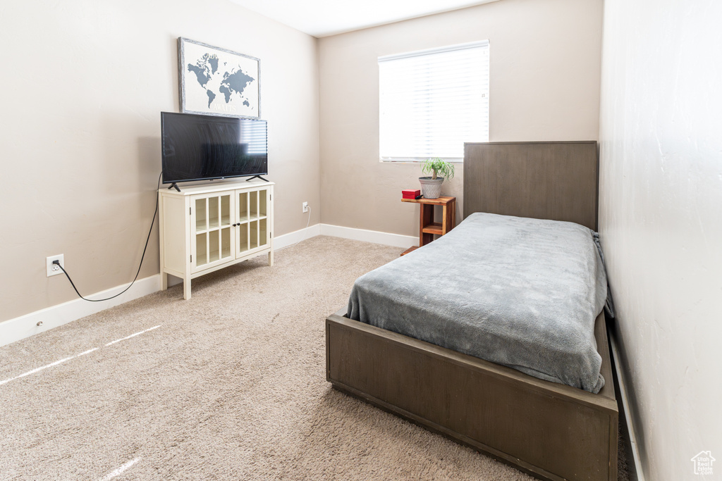 Carpeted bedroom with baseboards