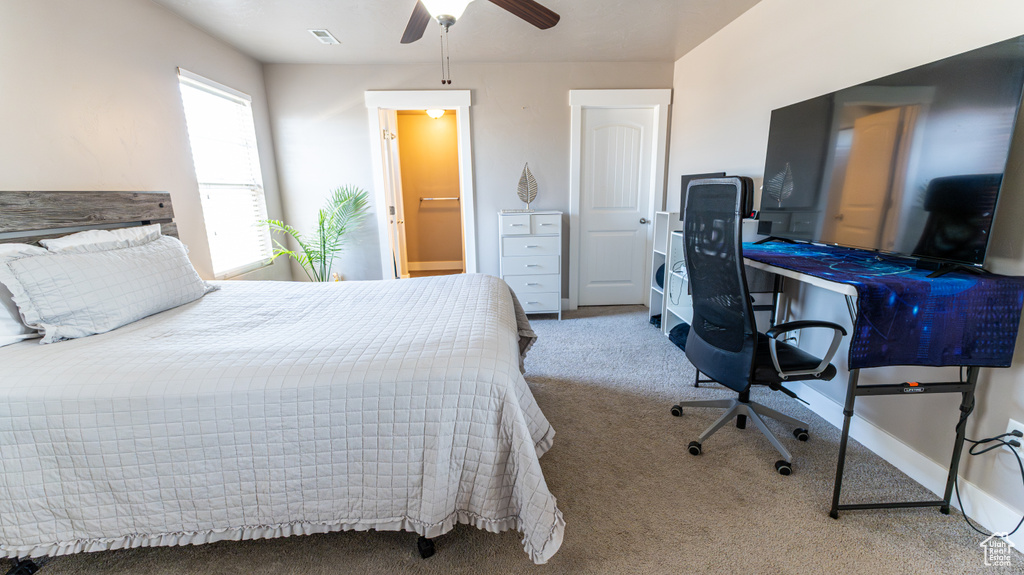 Bedroom with carpet flooring, an office area, and ceiling fan